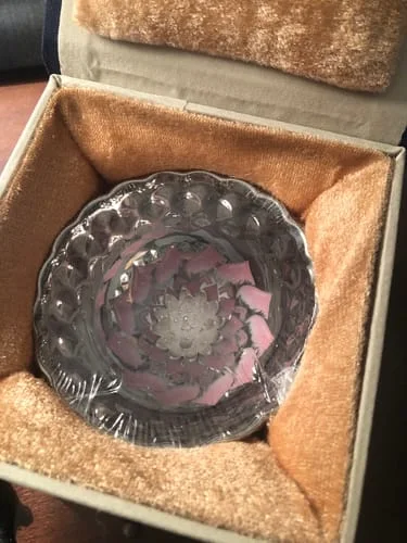 Reviewer's Vivid Lotus teacup with a pink lotus design, still wrapped inside its plush gift box.