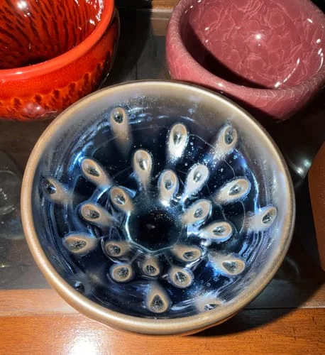 Customer's top-down view of the Peacock Eye tea cup, highlighting the unique interior glaze pattern.