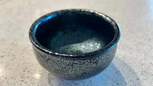 Customer's dark, textured Cells cup sitting on a kitchen counter.