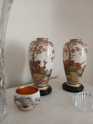 Customer's The Dragon tea cup with a golden interior, displayed on a white surface with other ceramics.